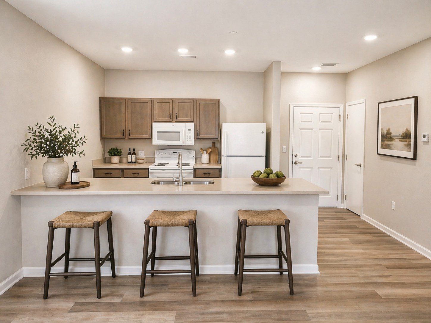 Modern kitchen with bar stools and decor.