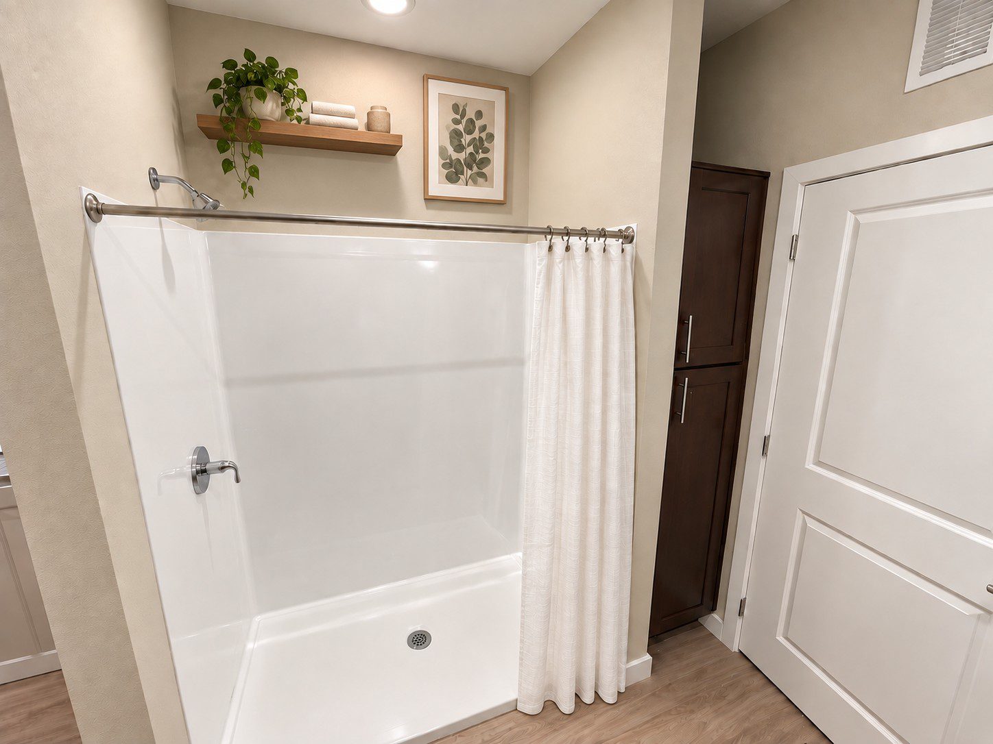 Modern bathroom with shower and storage cabinet.
