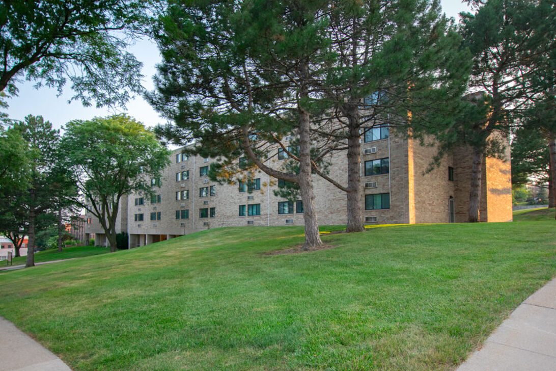 Brick apartment building with grassy lawn