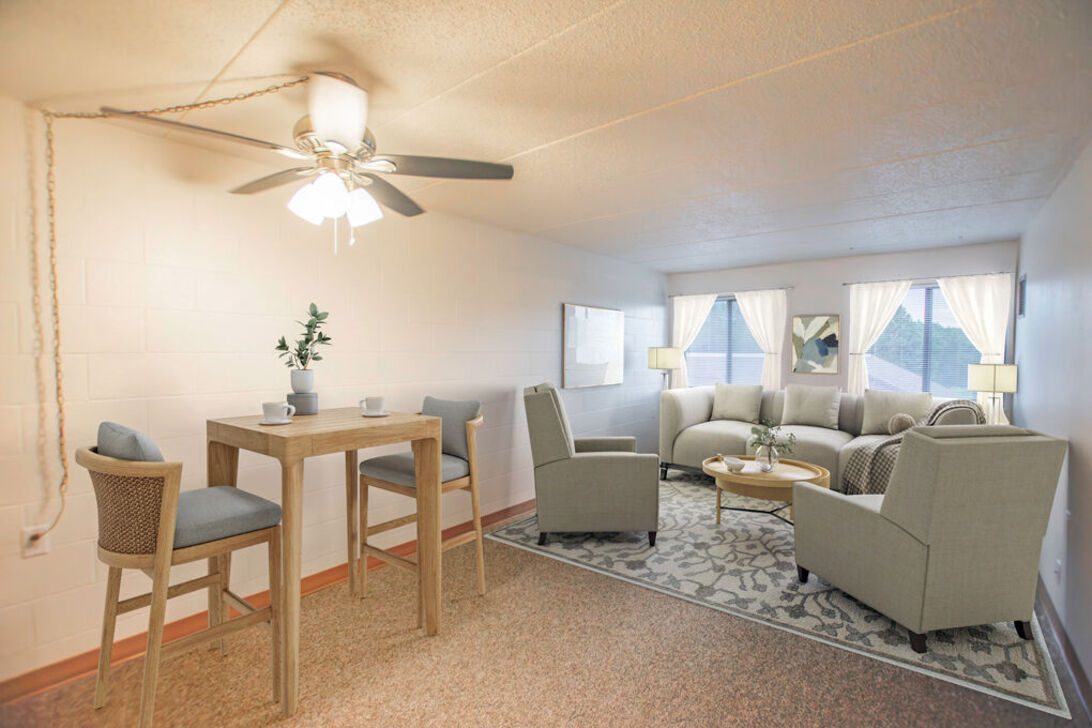 Bright living room with sofa and chairs
