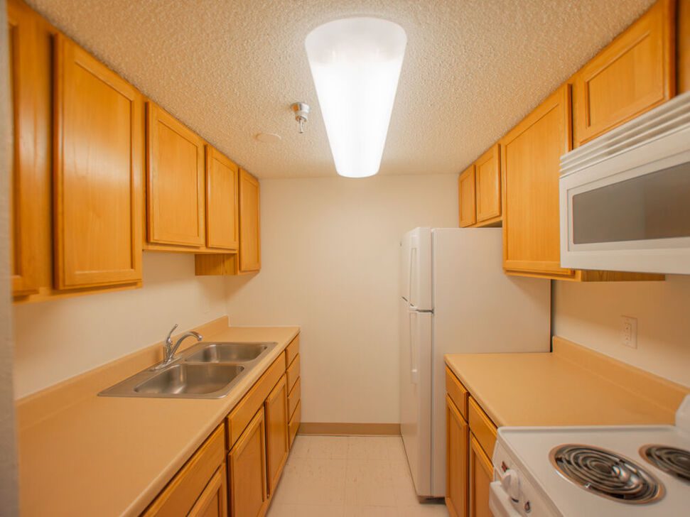 Small galley kitchen with wood cabinets