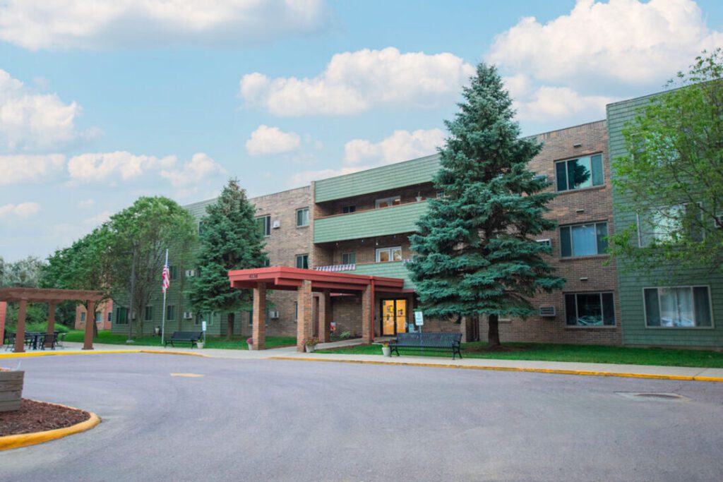 Apartment entrance with covered drive and flag