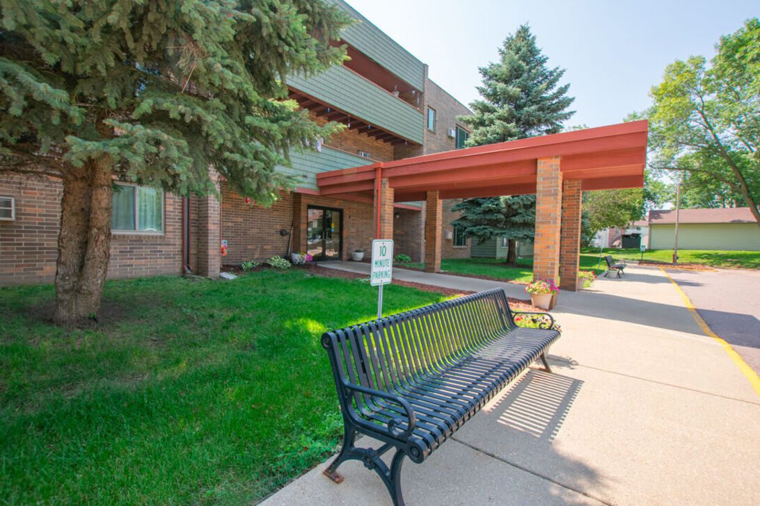 Entrance canopy with bench and landscaping
