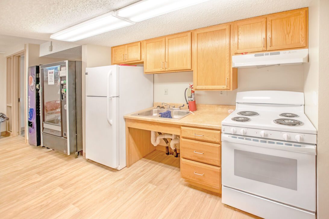 Small kitchenette with appliances and vending machines