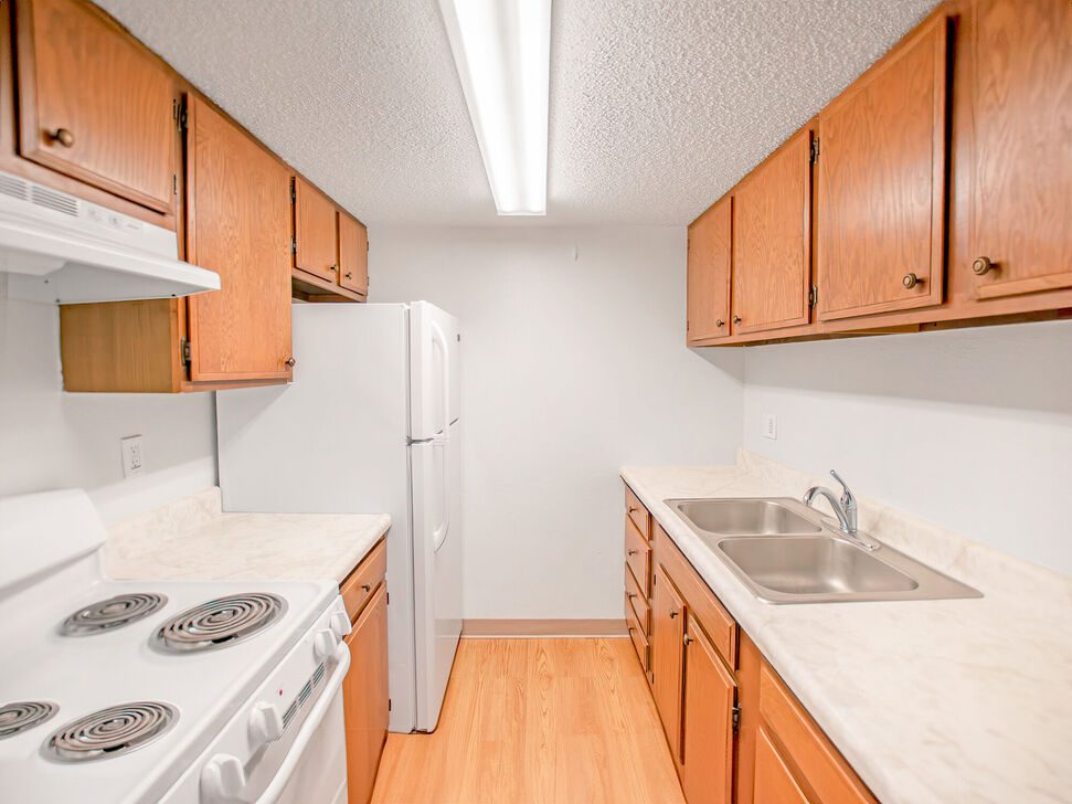 Compact galley kitchen with wooden cabinets